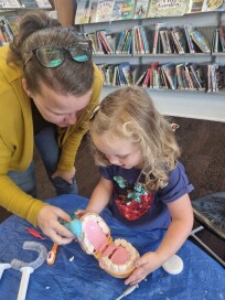 Mum & little girl playing dentist